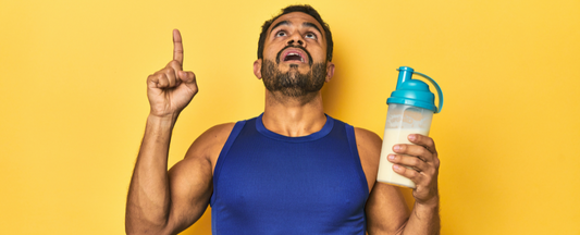 homem olhando para cima com copo de  whey na mão